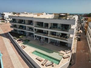 Modern beachfront apartment building with pool and outdoor lounge area in Cancun, Mexico. Isla Mujeres Mexico Property