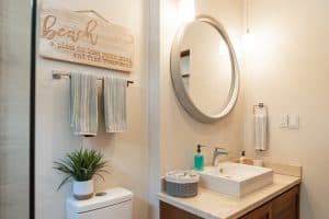 Bright bathroom with modern sink, mirror, and beach-themed decor for coastal living. Isla Mujeres Mexico Property