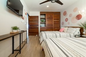 Modern bedroom with wooden closet, wall decor, and minimalist furniture in a stylish home.