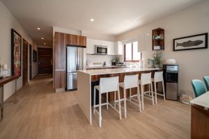 Modern kitchen with wooden accents and bar seating, perfect for contemporary coastal living in Mexic.