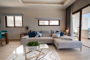 Modern living room with large windows, neutral tones, and stylish decor in a luxury property.