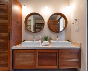Modern double vanity with round mirrors in a stylish bathroom setting.