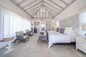Elegant bedroom with white decor and rustic ceiling at Mundaca Real Estate property in Mexico. Isla Mujeres Mexico Property