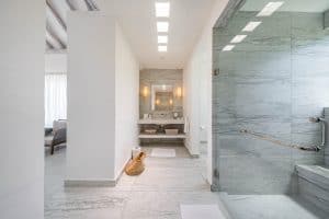 Relaxing spa bathroom with marble walls and modern amenities at Mundaca Real Estate. Isla Mujeres Mexico Property
