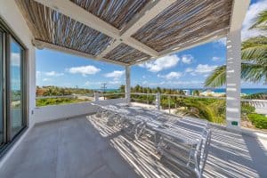 Elegant oceanview balcony with lounge chairs and tropical surroundings in Cancun, Mexico. Isla Mujeres Mexico Property