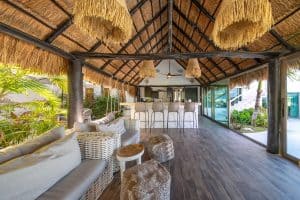 Relaxing beachfront lounge with thatched roof, modern furniture, and ocean views in Cancun, Mexico. Isla Mujeres Mexico Property