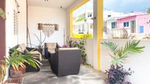 Modern outdoor terrace with comfortable seating and lush tropical plants in a vibrant residential ar. Isla Mujeres Mexico Property