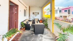 Modern outdoor patio with comfortable seating and vibrant plants at Mundaca Real Estate. Isla Mujeres Mexico Property