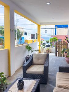 Relaxing outdoor patio with comfortable seating and vibrant plants, perfect for enjoying the warm we. Isla Mujeres Mexico Property