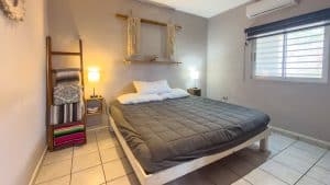 Modern bedroom with minimalist decor and natural light, ideal for real estate listings in Mexico. Isla Mujeres Mexico Property