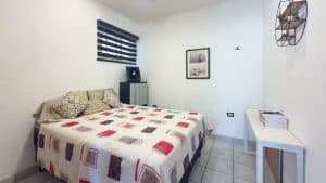 Cozy bedroom with modern decor and natural light in a residential property. Isla Mujeres Mexico Property
