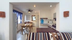 Bright interior of a modern Mexican home with kitchen and dining area, featuring colorful decor and. Isla Mujeres Mexico Property