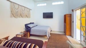 Spacious bedroom with modern decor and balcony access at Mundaca Real Estate property. Isla Mujeres Mexico Property