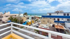 Coastal view of colorful buildings and the ocean from a balcony in Puerto Escondido, Oaxaca. Isla Mujeres Mexico Property