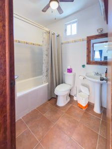 Bathroom with bathtub, toilet, and sink in a cozy home in Mundaca, Mexico. Isla Mujeres Mexico Property