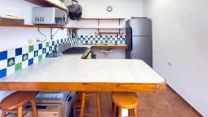 A modern kitchen with colorful tile backsplash and wooden accents at Mundaca Real Estate. Isla Mujeres Mexico Property
