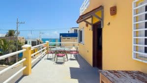 Beachfront terrace with outdoor seating and ocean view in a sunny coastal property. Isla Mujeres Mexico Property