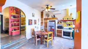 A cozy, colorful kitchen and dining area with vibrant decor and modern appliances in a Mexican home. Isla Mujeres Mexico Property