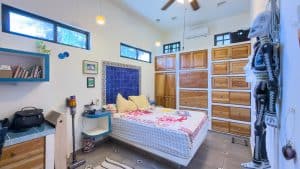 Modern bedroom with wooden furniture and colorful decor at Mundaca Real Estate. Isla Mujeres Mexico Property