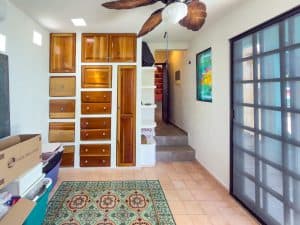 Modern interior with wooden storage cabinets and colorful artwork in a bright, welcoming home. Isla Mujeres Mexico Property