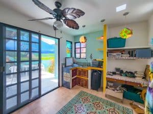 Bright interior room with sliding glass door, ceiling fan, and colorful decor, ideal for family livi. Isla Mujeres Mexico Property