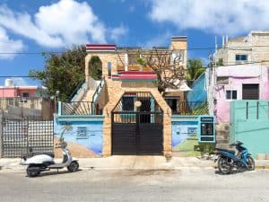 Colorful residential house in Puerto Escondido, Oaxaca, Mexico with vibrant murals and outdoor terra. Isla Mujeres Mexico Property