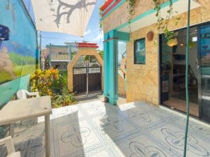 Bright outdoor patio with colorful walls, potted plants, and decorative tiles, ideal for relaxing or. Isla Mujeres Mexico Property