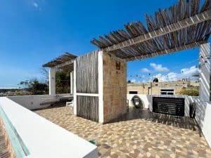 A lush rooftop terrace with wooden pergola and ocean view in Cancun, perfect for relaxing and entert. Isla Mujeres Mexico Property