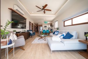 Modern living room with spacious seating, large windows, and contemporary decor in a luxury property.